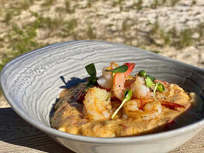 shrimp and grits in a clam shell bowl